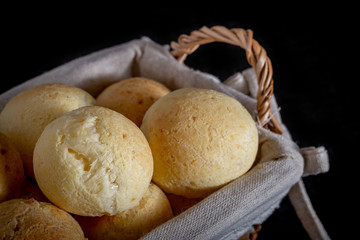Brazilian homemade cheese bread, AKA 'pao de queijo' in a rustic basket.