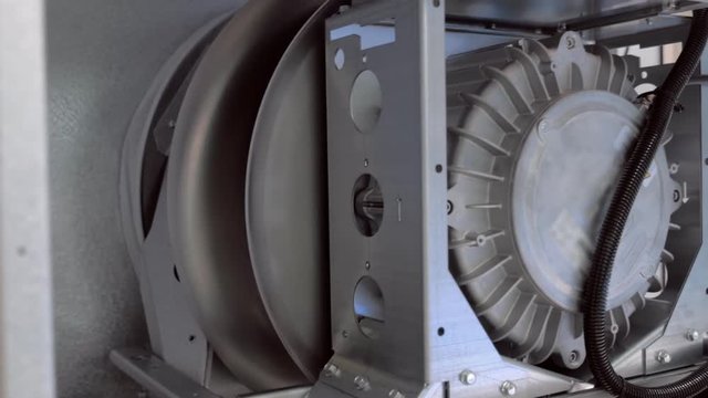 Industrial ventilation cooling equipment during operation. The impeller is moving the airflow. Shot in motion
