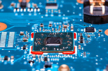 Glowing modern processor. Big illuminated graphic processor surrounding by other electrical...