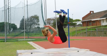 Female athlete practicing high jump at sports venue 4k