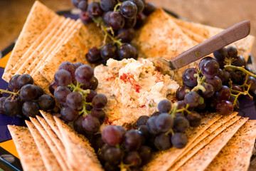 Crackers grapes cheese spread.