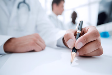 close up.doctor writing something in the lab journal.