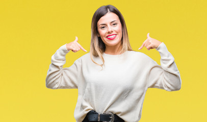 Young beautiful woman casual white sweater over isolated background looking confident with smile on face, pointing oneself with fingers proud and happy.