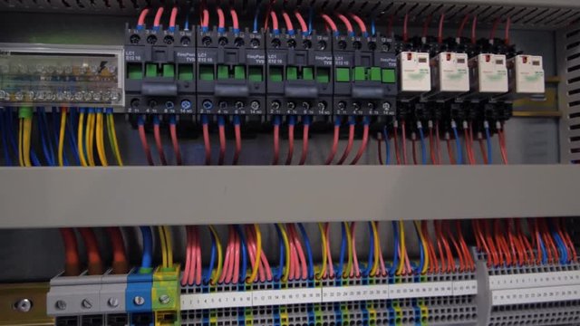 Electrical panel with multiple switches, wires, short circuit protection devices and electricity meter. Shot in motion