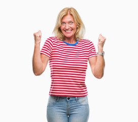 Fototapeta na wymiar Middle age blonde woman over isolated background celebrating surprised and amazed for success with arms raised and open eyes. Winner concept.