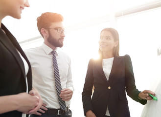 businesswoman pointing marker to flipboard on presentation in office
