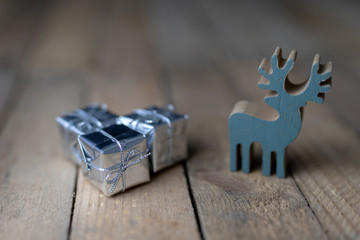 Christmas decorations on the kitchen table. Wooden Christmas figurines prepared for decorating a tree.