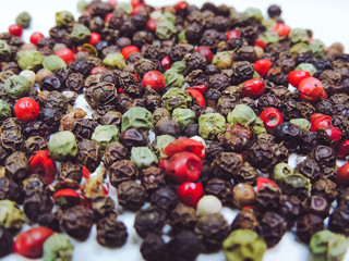 A mixture of pepper in the form of peas on a bright table