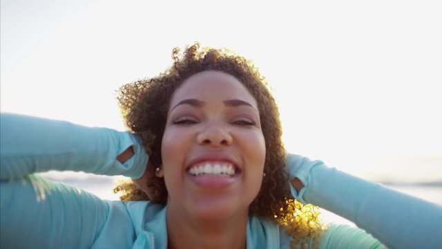 Portrait of Ethnic African American female using her camera to do a video diary on the beach 