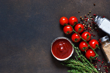 Tomato sauce with thyme, chili pepper and paprika on a dark background.