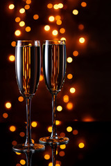 Festive evening together. Two glasses of wine against the lights