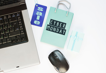 shopper with cyber monday paperbag, PC mouse, laptop. ticket label Sale tag - online shopping concept 