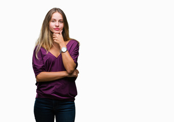 Young beautiful blonde elegant woman over isolated background looking confident at the camera with smile with crossed arms and hand raised on chin. Thinking positive.