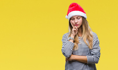 Young beautiful blonde woman wearing christmas hat over isolated background thinking looking tired and bored with depression problems with crossed arms.