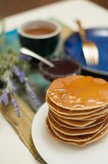 Breakfast with pancakes and tea with honey and jam