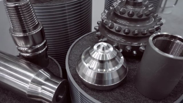 New, shiny metal parts related to the extraction oil and gas industry. Shot in motion