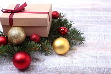 Christmas fir tree with gift box on wooden board