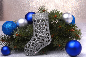 Christmas decoration. The boots of Santa Claus and Christmas tree branches on wooden background