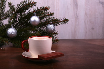 Coffee cup and chocolate on wooden table texture. Coffeebreak. Christmas time