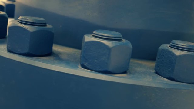 Powerful nuts on the huge blue industrial crane with red ventil. Shot in motion
