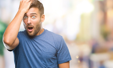 Young handsome man over isolated background surprised with hand on head for mistake, remember...