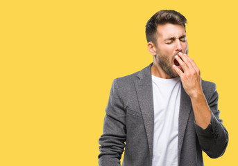 Young handsome business man over isolated background bored yawning tired covering mouth with hand....