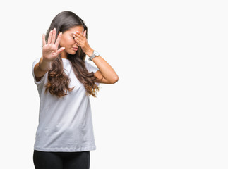 Fototapeta premium Young beautiful arab woman over isolated background covering eyes with hands and doing stop gesture with sad and fear expression. Embarrassed and negative concept.