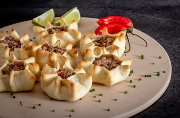 Arabian opened meat esfiha on rustic background.