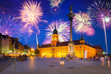 Fototapeta na wymiar Fireworks display over The Royal Castle square of Warsaw, Poland