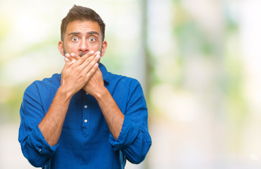 Adult hispanic man over isolated background shocked covering mouth with hands for mistake. Secret concept.