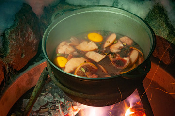 Cauldron with the mulled wine cooked over the fire