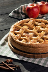 Apple pie and ingredients in natural light. Homemade pastry item.