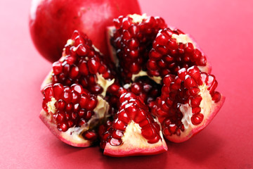 Ripe Pomegranates. sliced and whole pomegranate on a table.