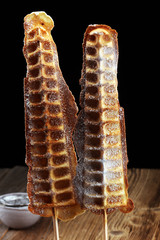 Belgium waffles with powder sugar. popsicles with chocolate and wafer.