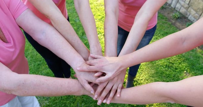 Group of women forming handstack in the garden 4k