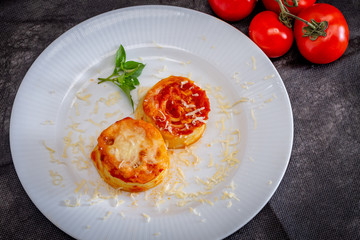 Italian rondelli with pomodoro sauce and cheese on rustic background.