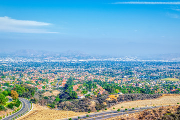 A road splits with houses of the city in the middle
