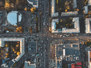 Road traffic on crossroad or intersection downtown of European city, aerial or top view