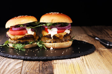 Tasty fresh meat burgers with salad and cheese. Homemade angus burger.
