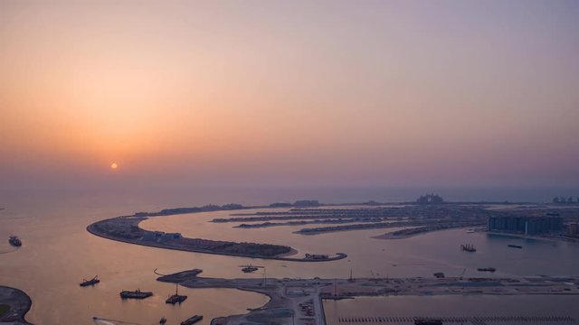 Sunset and night over the artificial islands of Dubai. Timelapse.