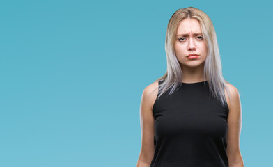 Young blonde woman over isolated background skeptic and nervous, frowning upset because of problem. Negative person.