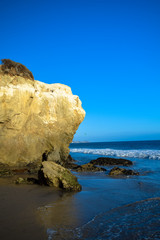 Fototapeta premium Rock formations in the late afternoon on El Matator State Beach in Malibu, California