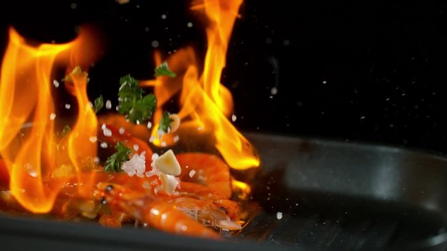 Super slow motion of falling prawns into flames, filmed on high speed cinema camera, 1000 fps.