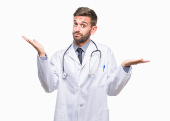 Young handsome doctor man over isolated background clueless and confused expression with arms and...