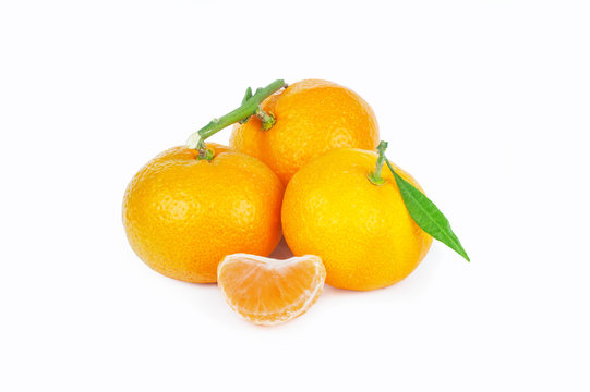 yellow sweet isolated peeled and whole mandarin clementine tangerine on white copy space with leaf. Tangerines background concept