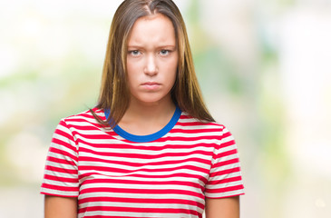 Young caucasian beautiful woman over isolated background skeptic and nervous, frowning upset because of problem. Negative person.