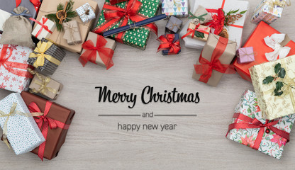 Merry Christmas and happy new year greetings in vertical top view wooden table full of christmas gifts presents.Xmas winter holiday season social media card background 