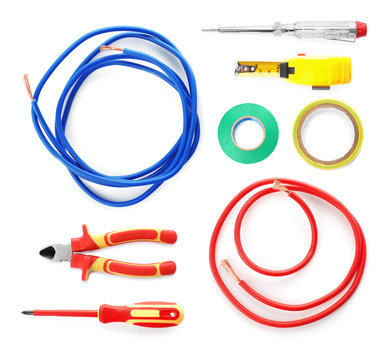 Electrician's professional tool set on white background, top view