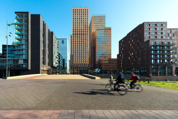 Office buildings in Amsterdam Zuid, Amsterdam, Netherlands. People bicycling in Amsterdam, Netherlands. © Prasit Rodphan