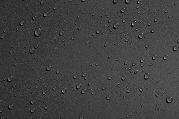 Water drops on black background, top view